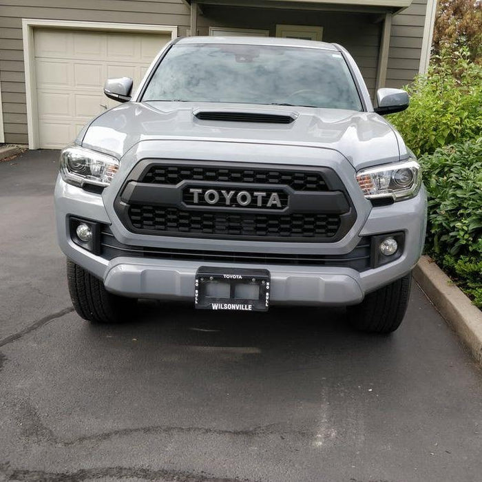 Silver 3rd Gen Toyota Tacoma with the TRD Pro style grille installed, front view